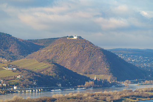 Vienna, Austria - 14 December 2023: view of the Donauinsel river island, Danube river, vineyards on hillsides, and the Leopoldsberg hill with St. Leopold's Church
