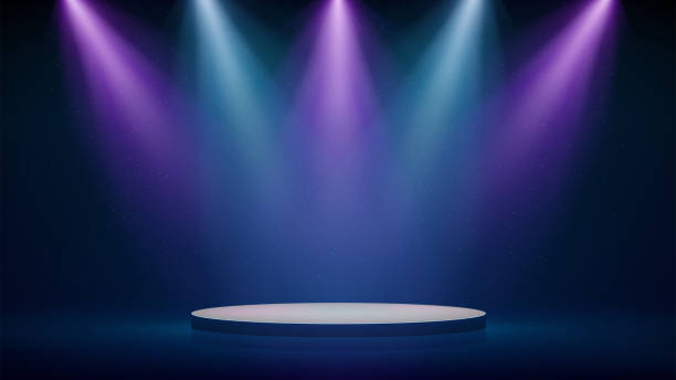 istock Stage, pink blue purple spotlights, podium. Background, backdrop for displaying products. Blue-pink stage spotlight on dark background. Beams of spotlights, glittering particles, a spot light. Vector 1992945453