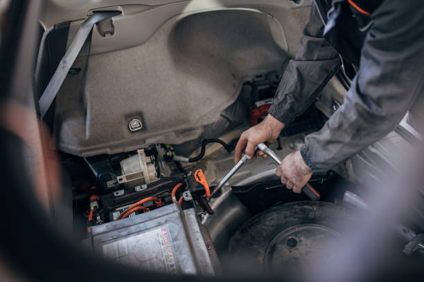 istock Mechanic repairing a car battery 1992951249