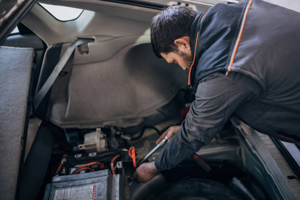 istock Mechanic repairing a car battery 1992952304