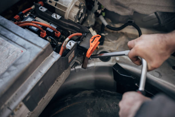 istock Mechanic repairing a car battery 1992953831