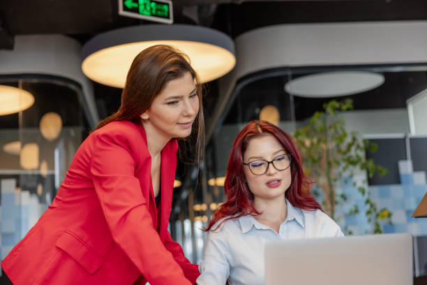 istock Two business partners discussing work in office. 1992977180