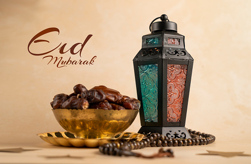 Eid Mubarak background 2024, Traditional Ramadan Lantern lamp with tasbih and Dates in a golden bowl, Islamic concept beige colour background