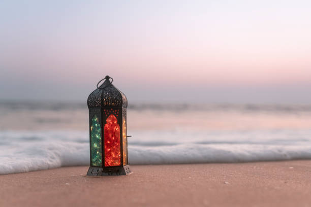 istock Lantern lamp on the beach with sunset background 1993022187