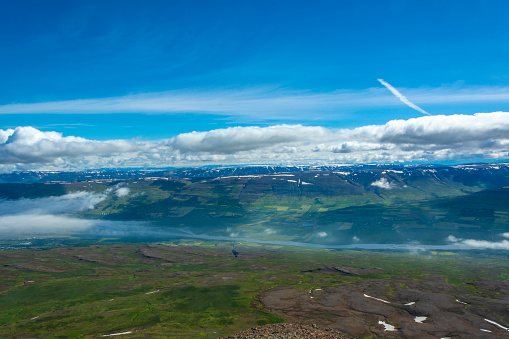 Aerial view of the mountains and the clouds in the blue sky