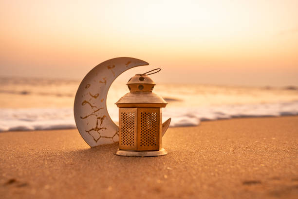 istock Traditional Candle light with Crescent moon shape on the beach 1993028999