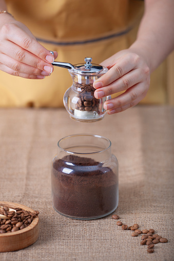 Professional woman barista preparing coffee using chemex\nHand drip coffee brewing on a Coffee House, alternative ways of brewing Coffee, Chemex, Moka Pot, V60