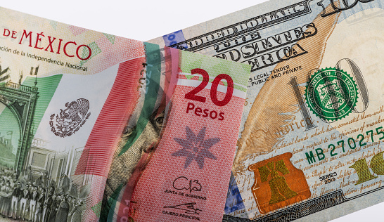 100 American dollars and 20 Mexican pesos bills