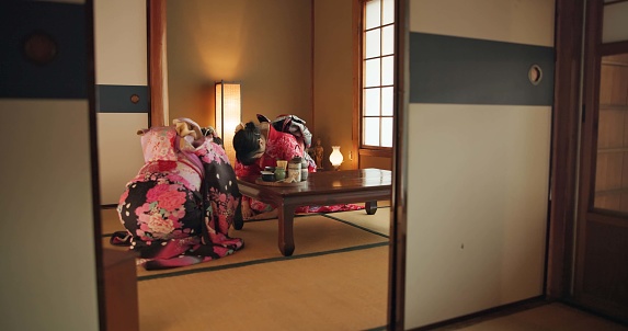 Traditional, bow and Japanese women with tea in home with herbs, leaves and flavor in teapot. Ritual, indigenous culture and people with herbal beverage for respect, drinking ceremony and wellness