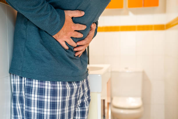 Adult male with abdominal pain and diarrhea in his bathroom. stock photo