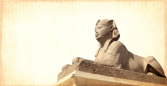Grunge background with paper texture and sphinx statue. Horizontal banner with ancient egyptian sphinx in Alexandria. Copy space for text. Mock up templat