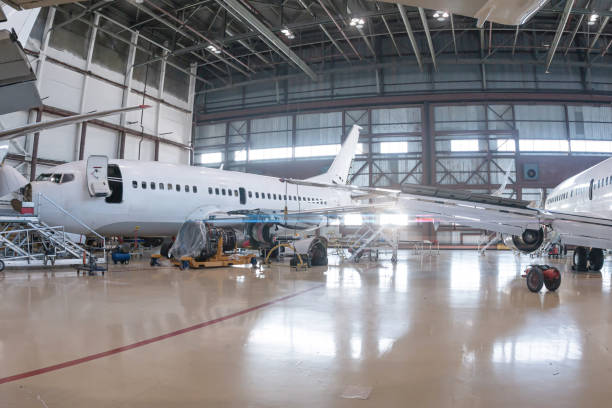 istock White passenger planes in the aviation hangar 1993091044