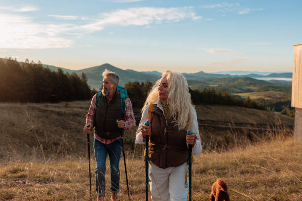 istock Cheerful couple hiking in afternoon. 1993097321