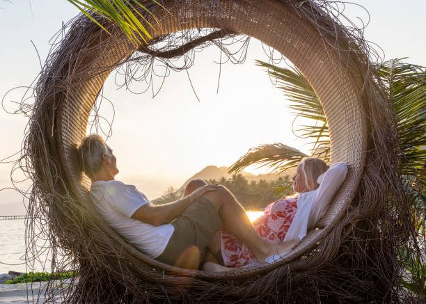istock Mature couple relax at water's edge 1993128855