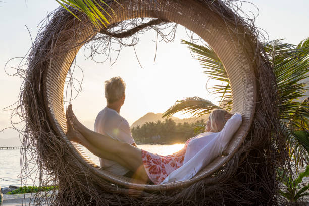 istock Mature couple relax at water's edge 1993128856
