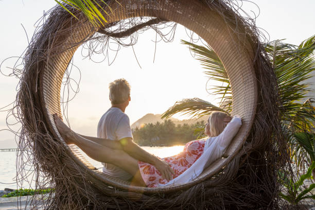 istock Mature couple relax at water's edge 1993129889