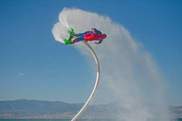 A man playing extreme fly board on the lake.