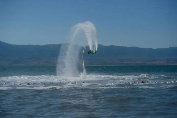 Photo of A man playing extreme fly board on the lake.