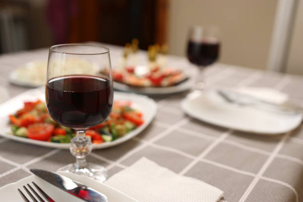 istock Festively laid table with glasses of red wine. 1993147484