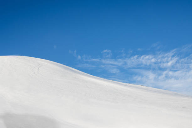 Beautiful autumn day, with a blue sky and white clouds. Fresh snow covering the wold with its waves and small hills. Nord-East Iceland.