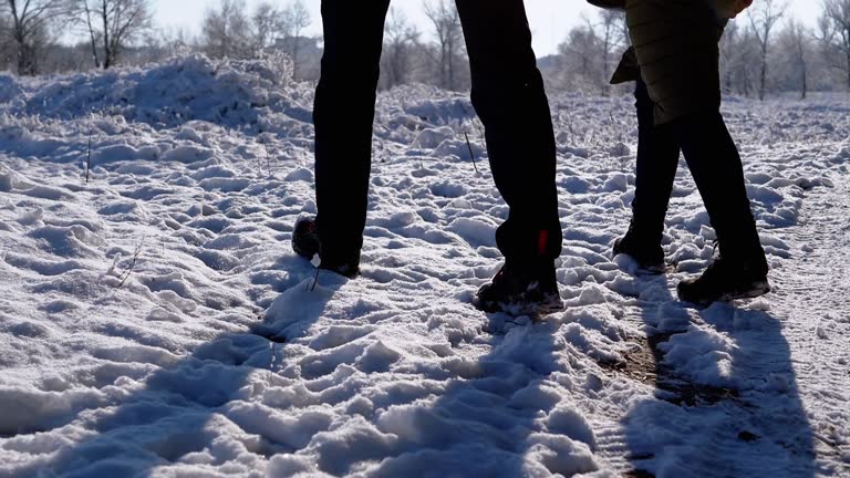 Silhouette Feet Loving Couple Walks by Winter Forest, Stepping on Fallen Snow