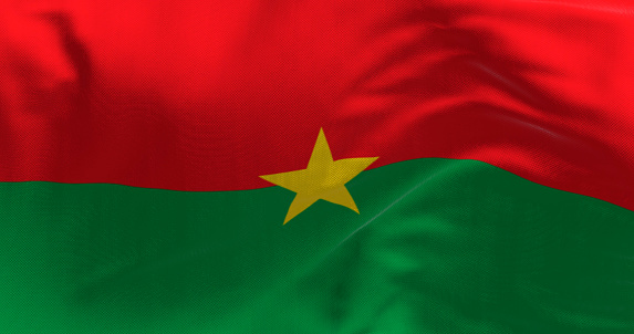 Close-up of national flag of Burkina Faso waving. Two equal horizontal red and green bands with a yellow five-pointed star in the center. 3d illustration render. Fluttering fabric. Textured background