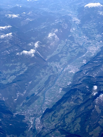 Earth surface landscape viewed from airplane under mountains.