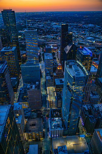 The beautiful illuminated downtown district of Houston, Texas shot at dusk via helicopter from an altitude of about 1000 feet directly over the city.
