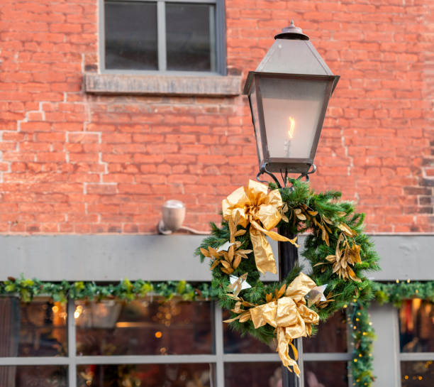istock Lamp post with greenery wreath and golden ribbons 1993210292