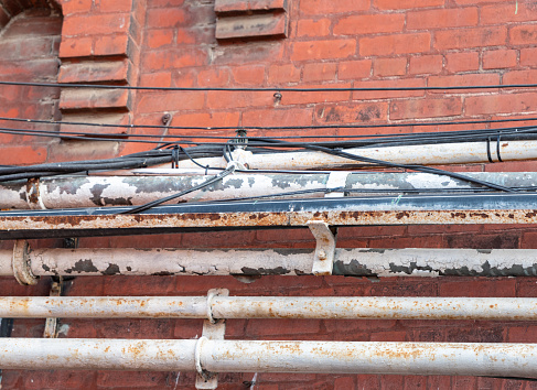 old painted rusted pipes on brick wall in Distillery District