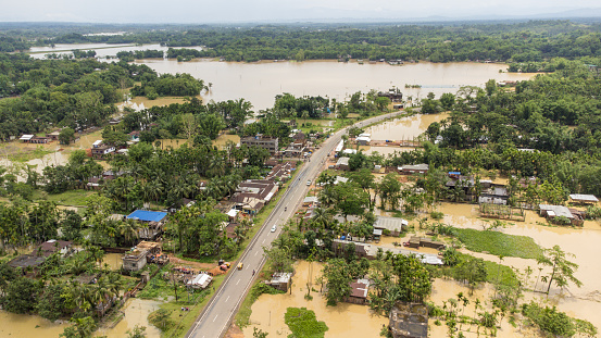 Aerial view of small town been Flooded countryside neighbourhood in Silchar, Assam India Barak River at 19 May 2022 Homes, houses overflowing muddy water concept of nature disaster climate change.