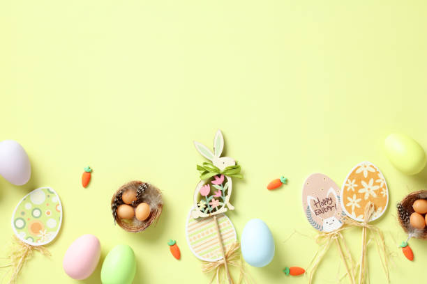 istock Happy Easter card. Flat lay Easter eggs, decorations, nest with eggs on green background. Top view. 1993243767