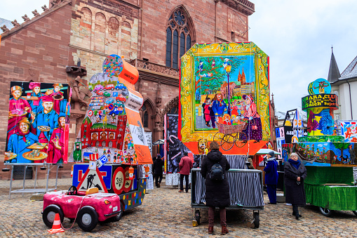Basel, Switzerland - February 28, 2023: Cathedral square with carnival lantern exhibition during annual traditional carnival in Basel, Switzerland