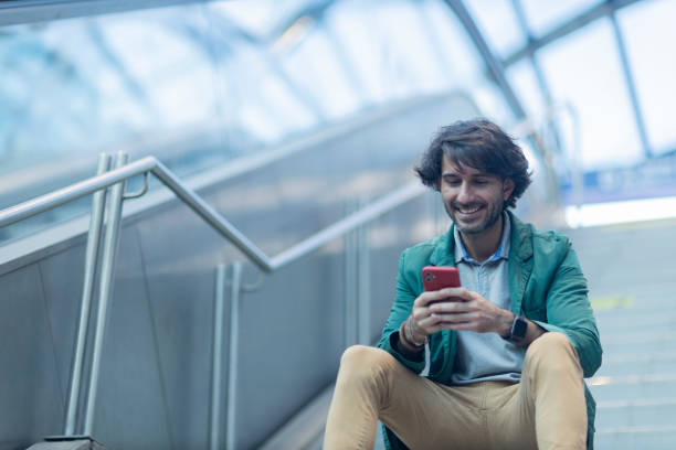 istock View of young man using a smartphone at indoor space with a blurred view landscape 1993273593