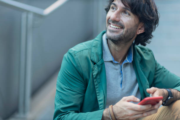istock View of young man using a smartphone at indoor space with a blurred view landscape 1993292004