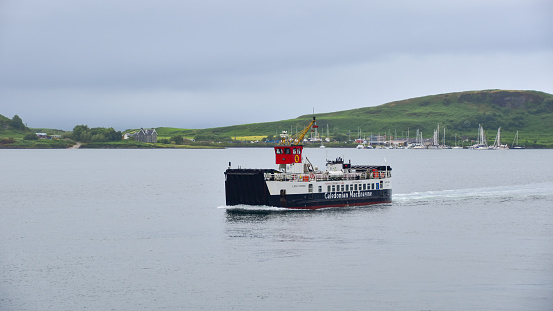 July 7, 2023 - Oban: Calmac ferry (Caledonian MacBrayne) boat leaving Oban harbour and sailing to Craignure, Isle of Mull. Scotland, United Kingdom, travel Europe.