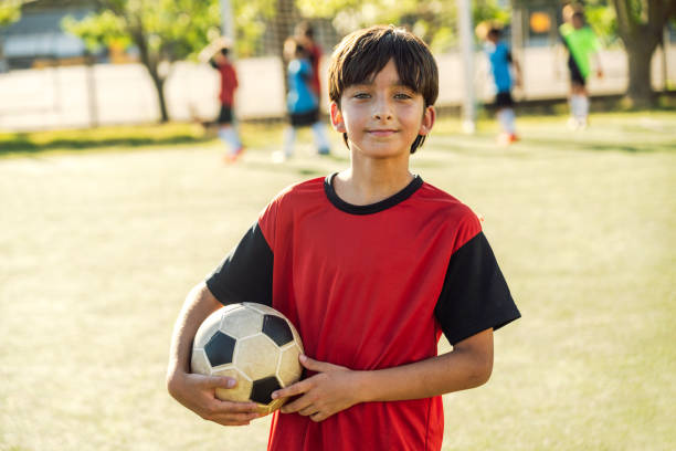 istock Confident Young Soccer Player Smiling on the Field at Sunset 1993337215