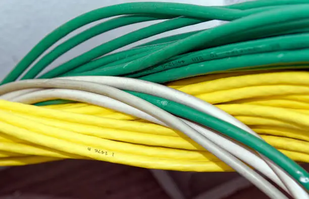 Photo of Bundles of intertwined, different colored network cables