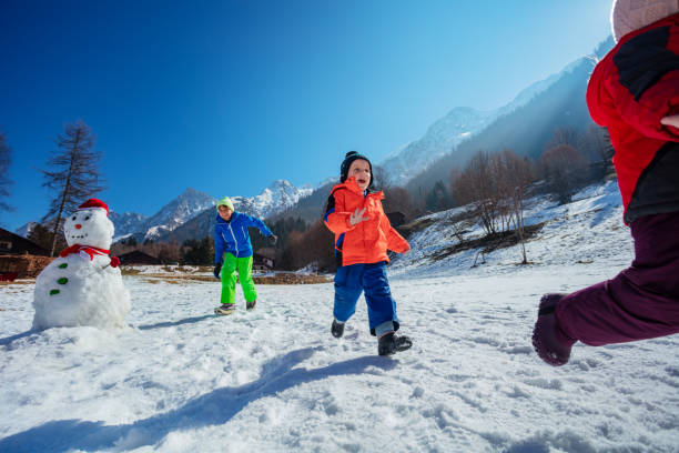 istock Dynamic shot of happy siblings run after each other in mountains 1993367851