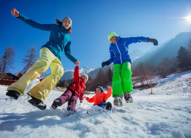 istock Family bonding fun outside over snowy shiny winter mountains 1993367862