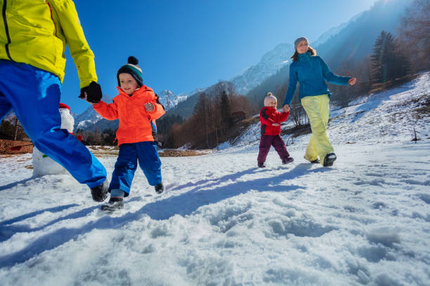istock Parents run with small kid in mountains enjoy winter vacations 1993368369