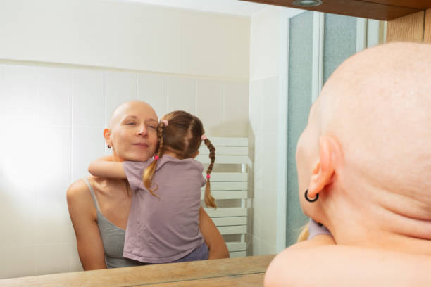 istock Mother with cancer and child share a tender hug view in mirror 1993373270