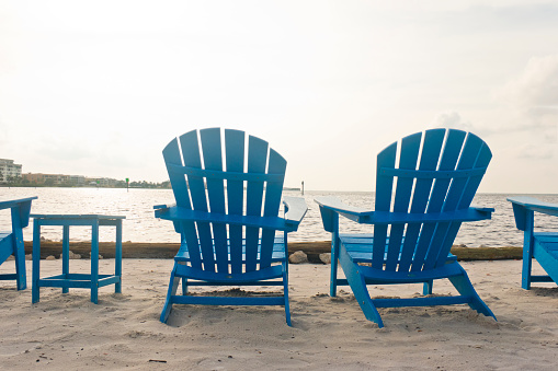 Adirondack Beach Chairs on a Beach under an overcast sky in south west Florida, USA.
