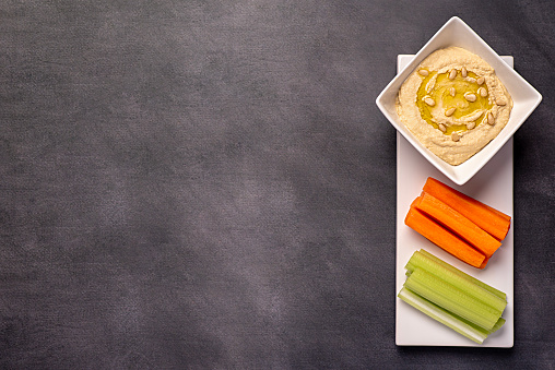Blank food photography of hummus, celery, carrot, snack, dip, vegan, vegetarian, chickpea, share, picnic