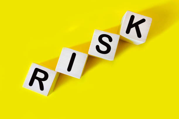istock The word RISK. Wooden letter cubes isolated on a yellow background with copy space available. Conceptual image. 1993398340