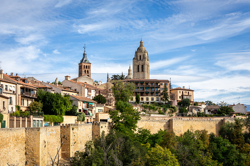 Segovia, Spain skyline with Segovia Cathedral at the top, churches, medieval architecture, residential buildings and city walls.
