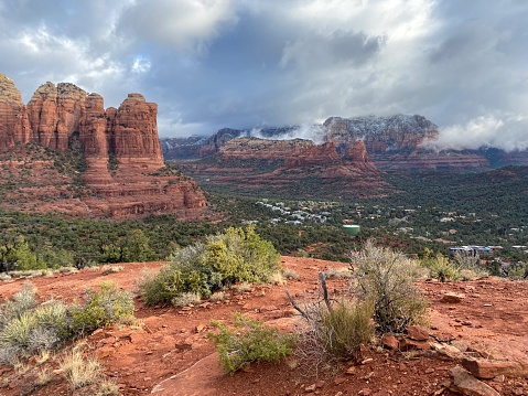 Beautiful views of the landscape and town view of Sedona, Arizona in winter, with Sedona surrounded by red-rock buttes, steep canyon walls and pine forests