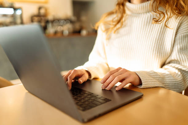 istock Close-up of hands working on a laptop keyboard. 1993432037