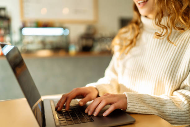 istock Close-up of hands working on a laptop keyboard. 1993432255