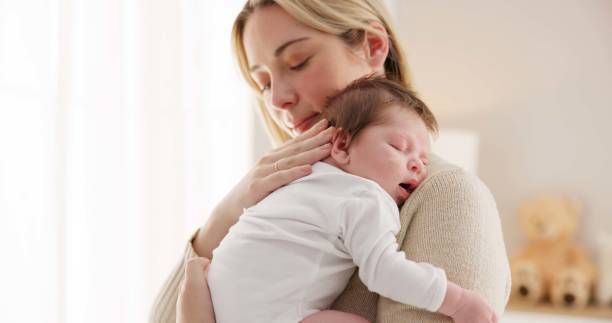 istock Sleeping, love and mother carry baby for bonding, relationship and child development together at home. Family, motherhood and happy mom with newborn for care, dreaming and affection in nursery room 1993445595